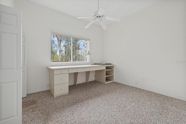 unfurnished office featuring light carpet and ceiling fan