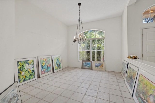 dining area featuring light tile patterned floors and an inviting chandelier