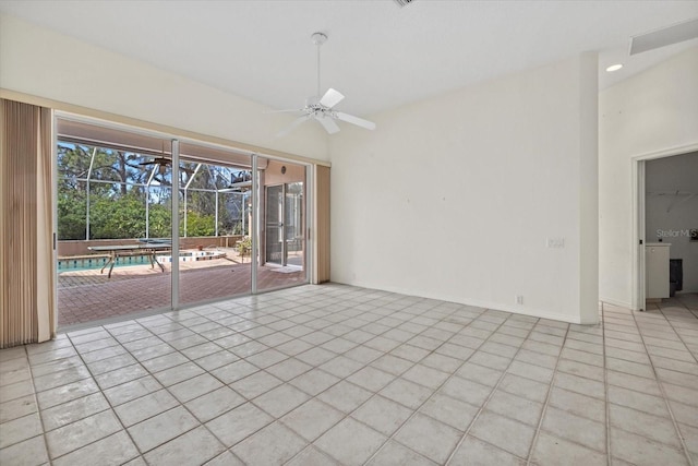 spare room with a ceiling fan, a sunroom, baseboards, and light tile patterned floors