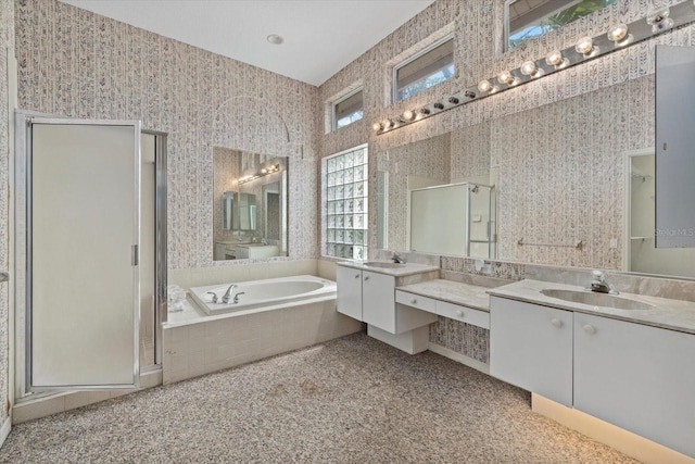 bathroom with a shower stall, a sink, and wallpapered walls