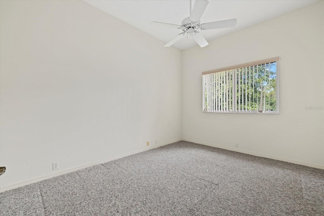 carpeted empty room with ceiling fan and baseboards