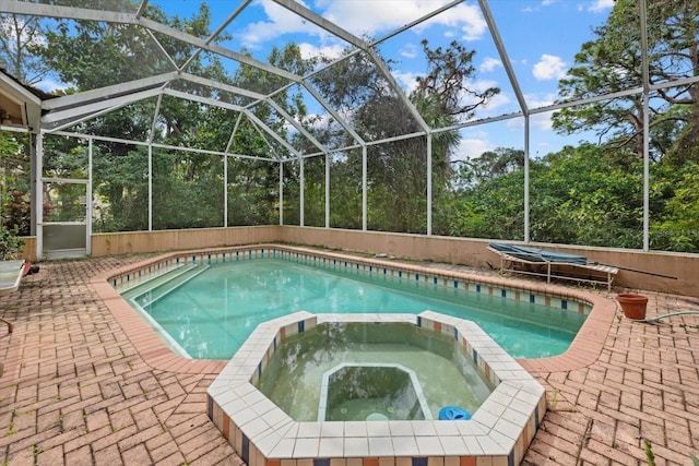 view of pool with a pool with connected hot tub and a patio