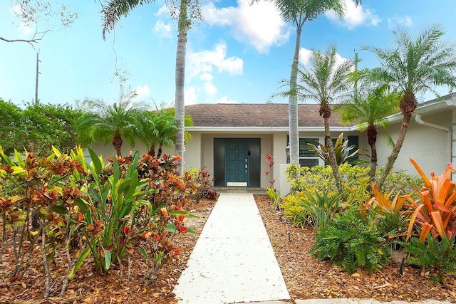 entrance to property with stucco siding