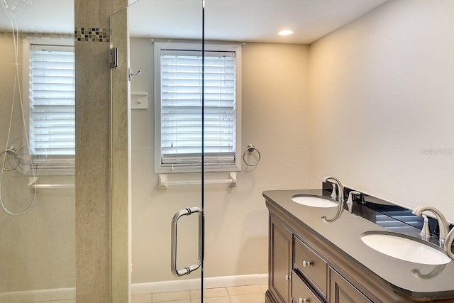 bathroom with a stall shower and a sink