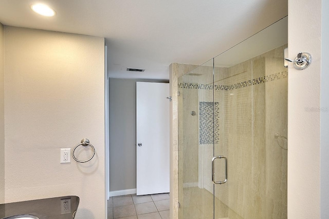 full bath with a shower stall, visible vents, and tile patterned flooring