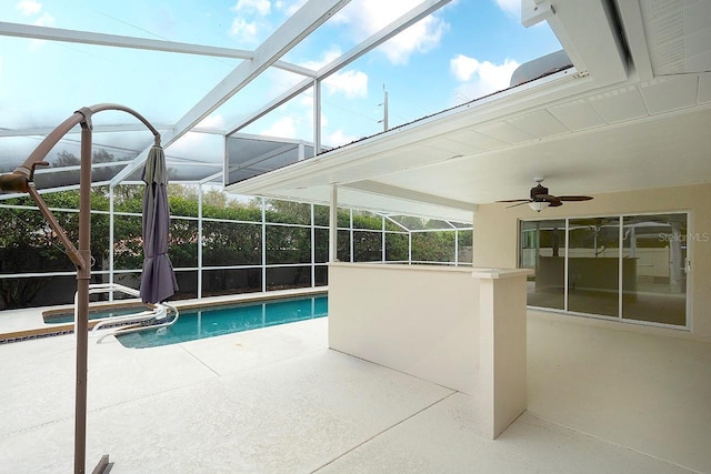 view of pool with a patio, a lanai, a pool with connected hot tub, and a ceiling fan