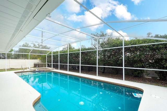 view of pool featuring a fenced in pool, a patio area, fence, an in ground hot tub, and a lanai