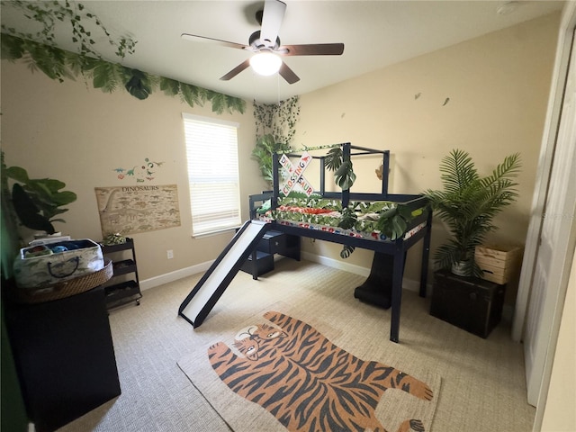 game room featuring light colored carpet, a ceiling fan, and baseboards