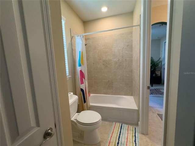 full bathroom featuring tile patterned flooring, shower / bathtub combination with curtain, and toilet