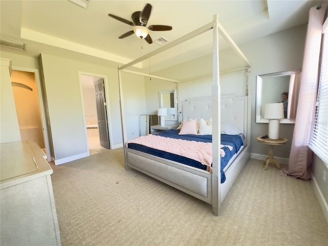 bedroom with carpet, connected bathroom, visible vents, and baseboards