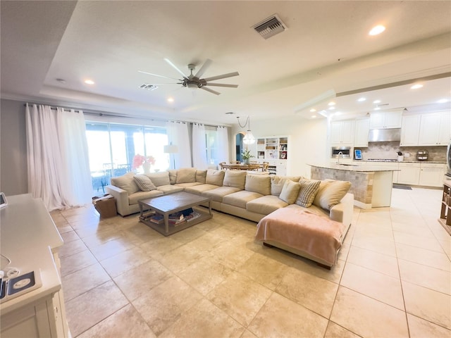 living room featuring recessed lighting, a raised ceiling, visible vents, and light tile patterned flooring