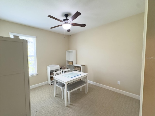 office area with a ceiling fan and baseboards