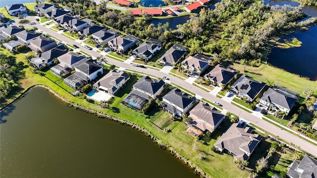 drone / aerial view with a water view and a residential view