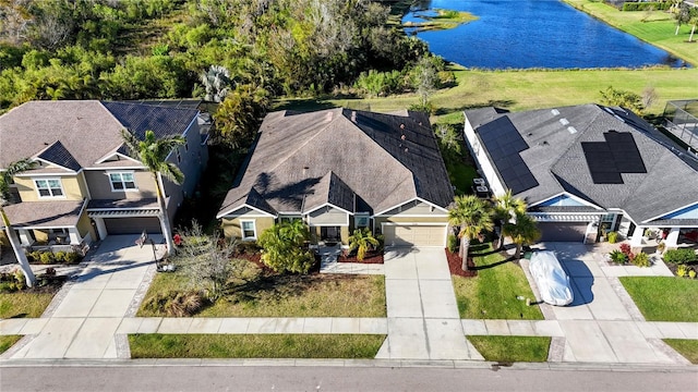 birds eye view of property featuring a water view and a residential view