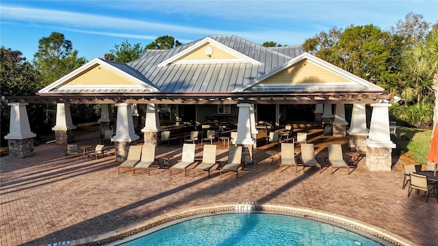 pool with outdoor dry bar and a patio