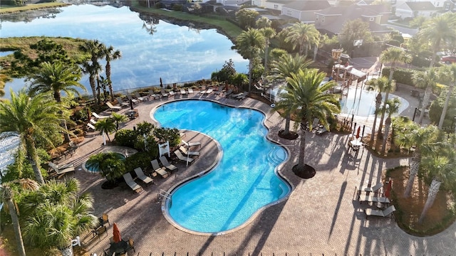 community pool featuring a patio and a water view