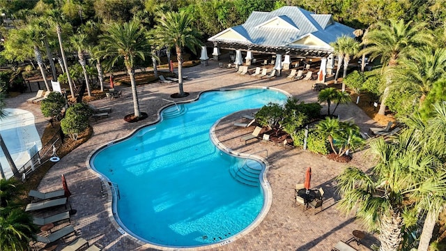 community pool featuring a pergola and a patio