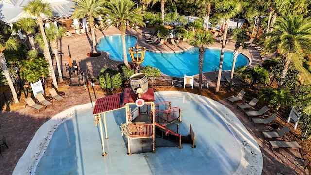 community pool featuring a water play area and a patio