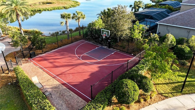 view of basketball court with a water view, fence, and basketball court