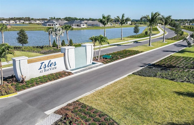 view of street featuring a residential view and a water view