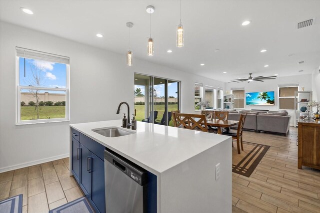 kitchen with a sink, a wealth of natural light, visible vents, and dishwasher