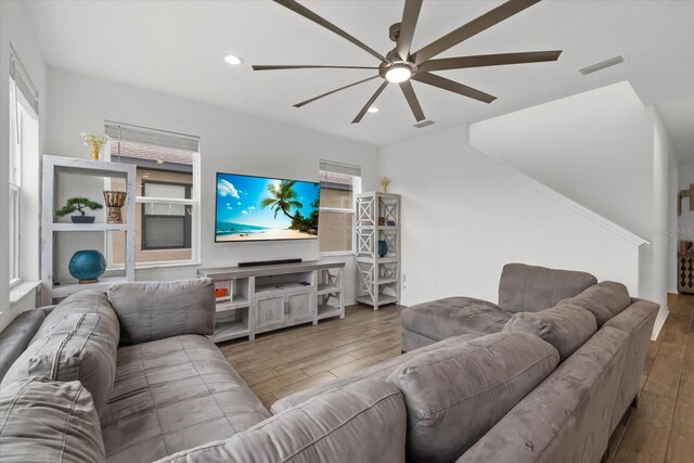 living room with a ceiling fan, recessed lighting, wood finished floors, and visible vents