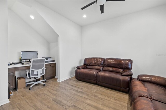 office space featuring lofted ceiling, light wood-style floors, baseboards, recessed lighting, and a ceiling fan
