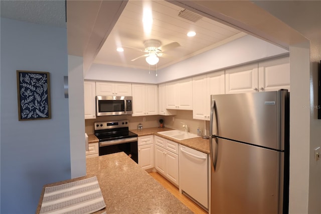 kitchen with a sink, visible vents, white cabinetry, appliances with stainless steel finishes, and light wood-type flooring