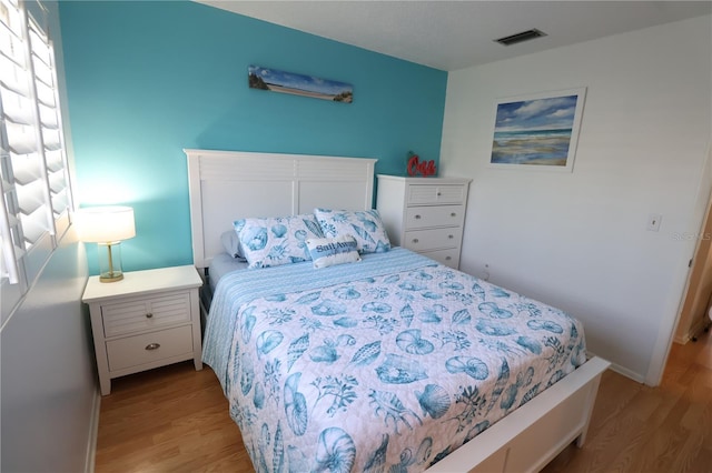 bedroom featuring light wood-type flooring and visible vents