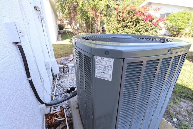 exterior details featuring central AC and a hot tub