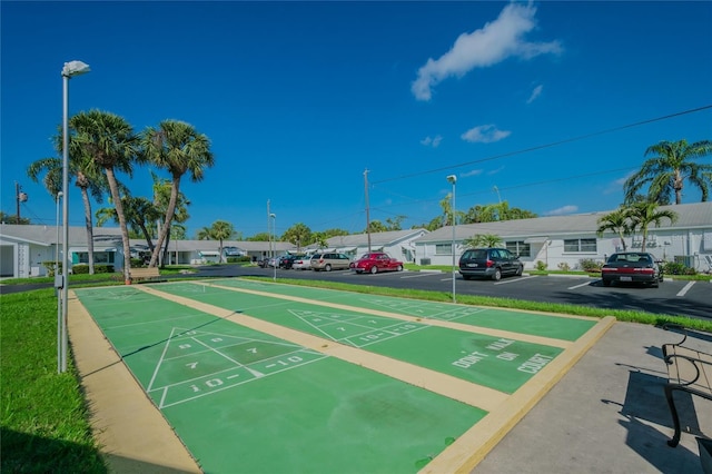 view of community featuring uncovered parking, a residential view, and shuffleboard