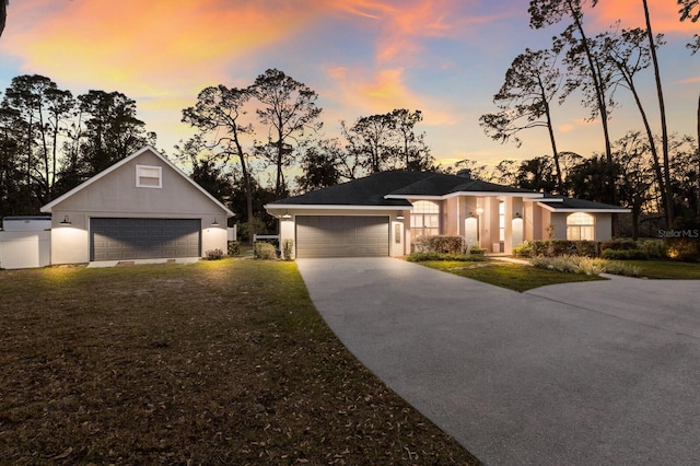 view of front of home featuring a garage and a lawn