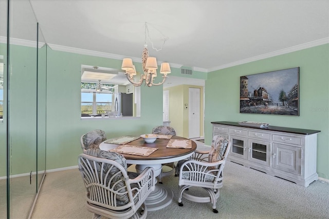 carpeted dining space featuring baseboards, crown molding, visible vents, and a notable chandelier