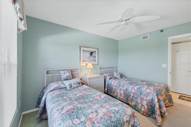 carpeted bedroom with ceiling fan, visible vents, and baseboards