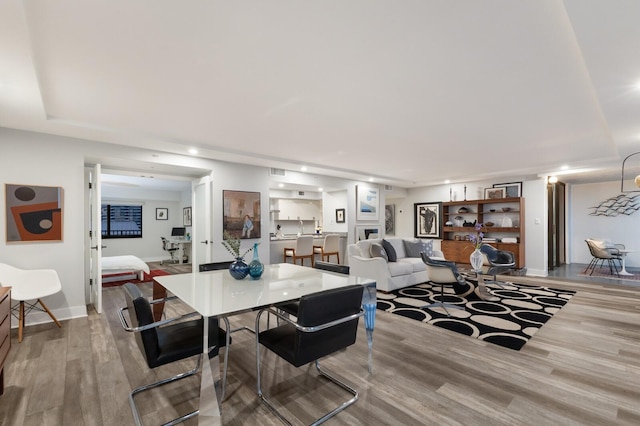 dining area featuring visible vents, baseboards, wood finished floors, and recessed lighting