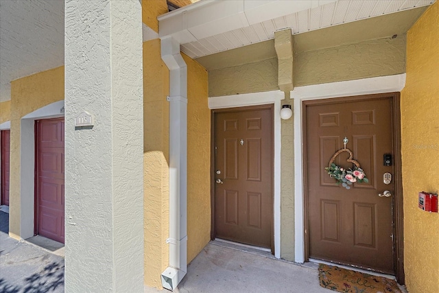 property entrance with stucco siding