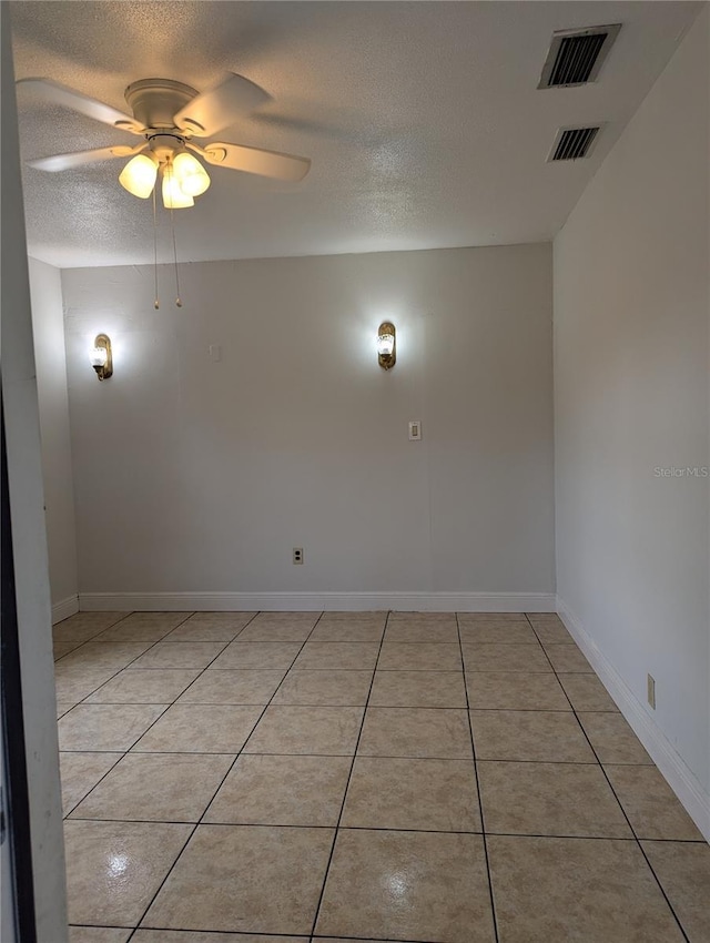 1807 48th Ave W, Bradenton, FL 34207 - empty room featuring a textured ceiling, ceiling fan, light tile patterned flooring, and baseboards