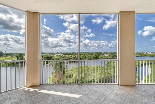 unfurnished sunroom with a water view