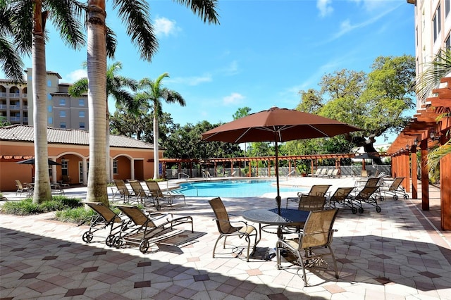 pool featuring fence and a patio