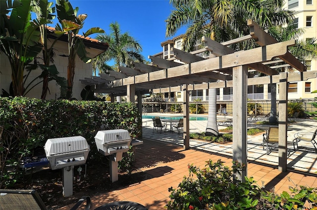 view of patio / terrace with a community pool and a pergola