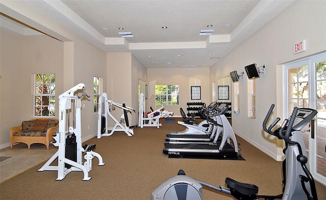 gym with recessed lighting, visible vents, a towering ceiling, and baseboards