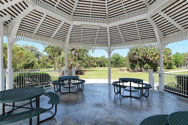 view of property's community featuring a yard, outdoor dining space, and a patio area