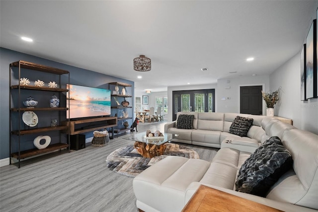 living room with wood finished floors, recessed lighting, visible vents, and baseboards