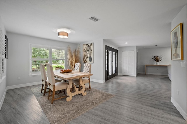 dining room with wood finished floors, recessed lighting, baseboards, and visible vents