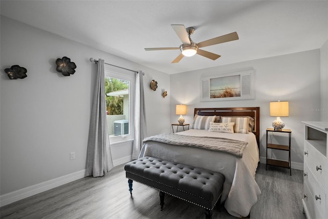 bedroom with baseboards, light wood-style floors, and a ceiling fan