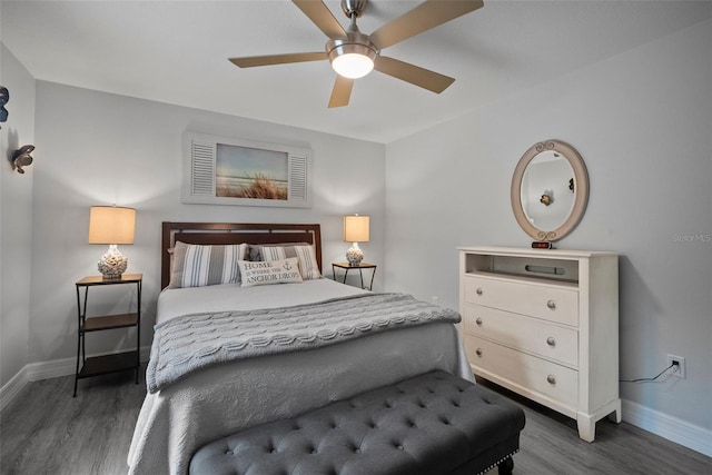 bedroom featuring a ceiling fan, wood finished floors, and baseboards