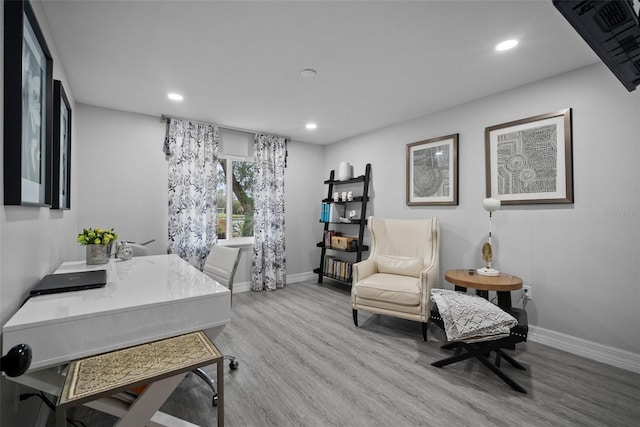 office space featuring recessed lighting, baseboards, and wood finished floors