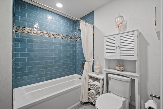 bathroom featuring toilet and shower / tub combo with curtain