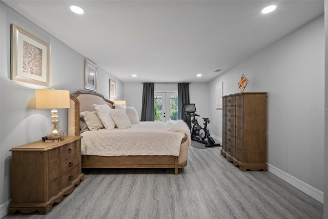 bedroom featuring recessed lighting, baseboards, light wood-type flooring, and french doors