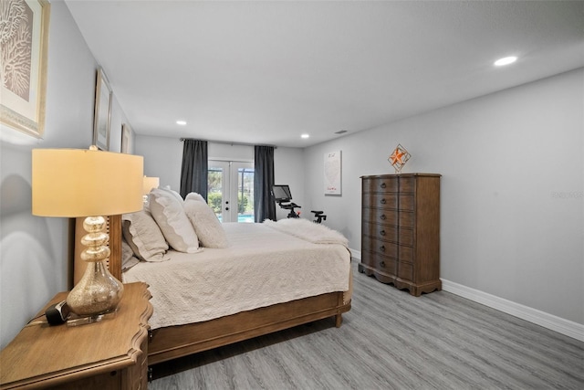 bedroom featuring wood finished floors, baseboards, recessed lighting, access to exterior, and french doors